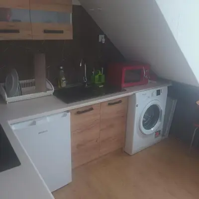 a bedroom with a bed and a dining room table at apartament przytulny in Ogrodzieniec