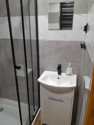 a kitchen with a white refrigerator and a washing machine at apartament przytulny in Ogrodzieniec