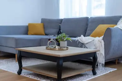 a living room with a blue couch and a coffee table at Mieszkanie na Groblach in Kraków