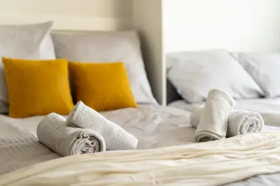 a white bed with towels and pillows on it at Mieszkanie na Groblach in Kraków