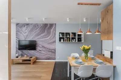a dining room with a table and a tv at Mieszkanie na Groblach in Kraków