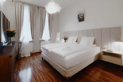 a bedroom with a large white bed and windows at Tarlowska - Free Parking - Near Castle, Main Square & River - 3 bedroom, loggia, 2xTV 4K in Kraków