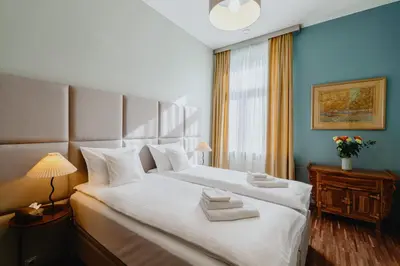 a bedroom with a large bed with towels on it at Tarlowska - Free Parking - Near Castle, Main Square & River - 3 bedroom, loggia, 2xTV 4K in Kraków