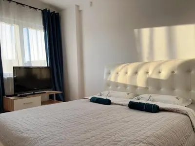 a bedroom with two beds and a clock on the wall at Pokoje Krakow Plus in Kraków