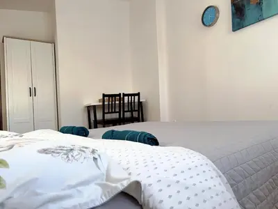 a room with a door and a desk with a lamp at Pokoje Krakow Plus in Kraków