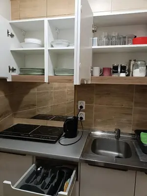 a black tea kettle sitting on a stove in a kitchen at Pokoje Krakow Plus in Kraków