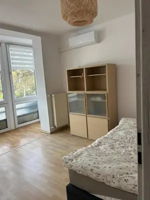a bedroom with a bed and a large window at Słoneczna Pleszowska in Kraków