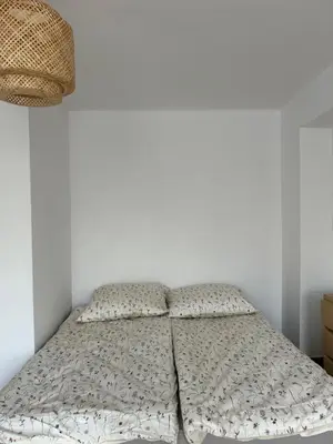 a bed in a white room with two pillows at Słoneczna Pleszowska in Kraków
