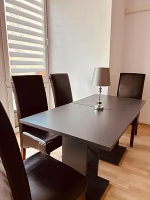 a dining room table with chairs and a lamp on it at Słoneczna Pleszowska in Kraków