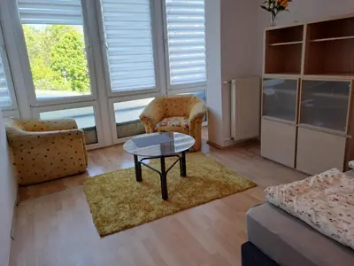 a living room with a couch and a table at Słoneczna Pleszowska in Kraków