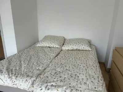 a bed with two pillows on it in a bedroom at Słoneczna Pleszowska in Kraków