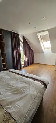 a bedroom with a bed in a room with a window at Villa Kozikowka lake and forest near Krakow and Wieliczka in Ulesie