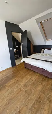 a bedroom with a bed and a wooden floor at Villa Kozikowka lake and forest near Krakow and Wieliczka in Ulesie