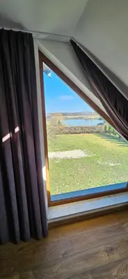 a window with a view of a field at Villa Kozikowka lake and forest near Krakow and Wieliczka in Ulesie