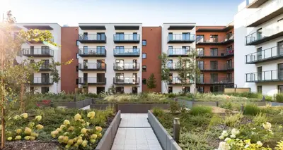 an apartment garden in front of a building at Salsa Apartament in Kraków