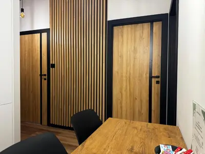 a conference room with a table and a wooden door at Salsa Apartament in Kraków