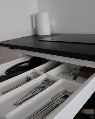 a drawer filled with silver utensils in a refrigerator at Klimieckiego 8A BW Apartments in Kraków