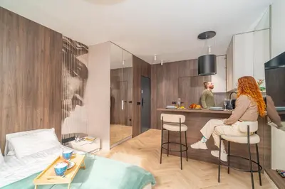 a man and a woman standing in a kitchen in a apartment at Angel's apartments - by Hosty in Kraków