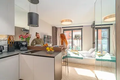 a living room with a couch and a table with fruit on it at Angel's apartments - by Hosty in Kraków