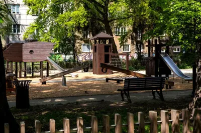 a park with a playground with slides and a bench at Travelers Haven Spacious 70m2 2 Bedrooms Balcony Old Town Area in Kraków