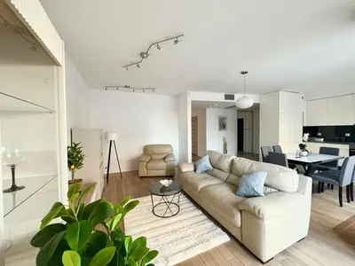 a white living room with a couch and a table at Lux 2bed, Wawel Castle, parking in Kraków