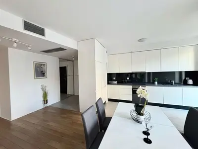 a bedroom with a bed and a pendant light at Lux 2bed, Wawel Castle, parking in Kraków