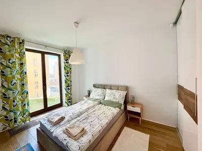 a kitchen and dining room with a table and chairs at Lux 2bed, Wawel Castle, parking in Kraków