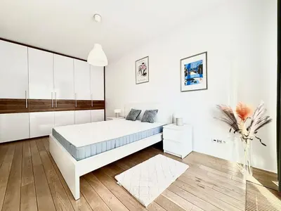 a white bedroom with a large bed and white cabinets at Lux 2bed, Wawel Castle, parking in Kraków