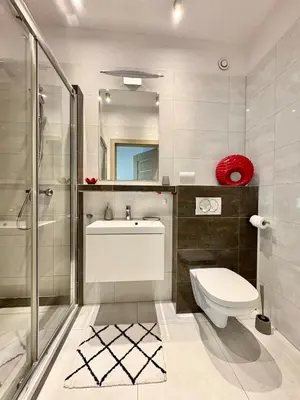 a bathroom with a toilet and a sink and a shower at Lux 2bed, Wawel Castle, parking in Kraków