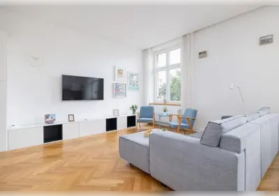 a living room with a couch and a tv at Apartament Rodzinny w Centrum Krakowa by Noclegi Renters in Kraków