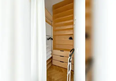 a room with a closet and a chair in it at Apartament Rodzinny w Centrum Krakowa by Noclegi Renters in Kraków
