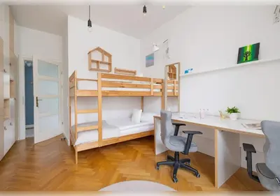 a room with a desk and a bunk bed at Apartament Rodzinny w Centrum Krakowa by Noclegi Renters in Kraków