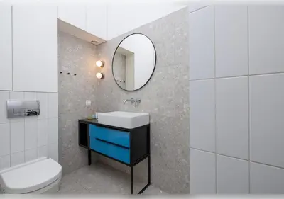 a bathroom with a sink and a toilet and a mirror at Apartament Rodzinny w Centrum Krakowa by Noclegi Renters in Kraków