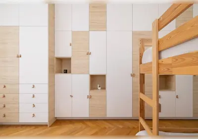 a bedroom with white cabinets and a bunk bed at Apartament Rodzinny w Centrum Krakowa by Noclegi Renters in Kraków