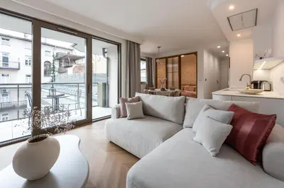 a living room with a white couch and a large window at Aurum by MB Apartments in Kraków