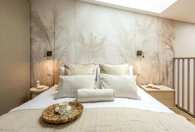 a bedroom with a large white bed with a wall mural at Aurum by MB Apartments in Kraków