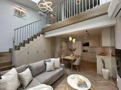 a living room with a couch and a table at Aurum by MB Apartments in Kraków