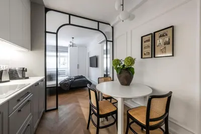 a kitchen and dining room with a table and chairs at Aurum by MB Apartments in Kraków