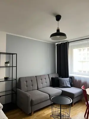 a living room with a couch and a table at Tomasza 25 Main Square Apartment in Kraków