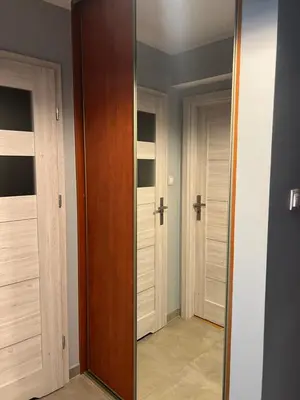 a mirror in a room with two doors at Tomasza 25 Main Square Apartment in Kraków
