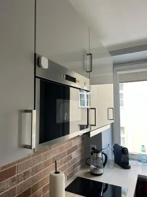 a kitchen with a microwave and a stove top oven at Tomasza 25 Main Square Apartment in Kraków