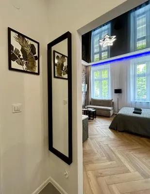 a living room with a mirror and a bedroom at Sky Mirror jacuzzi in Kraków
