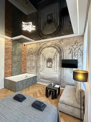 a bedroom with a bed and a bath tub at Sky Mirror jacuzzi in Kraków