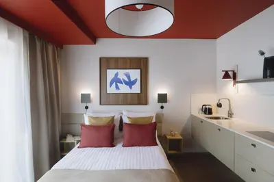a bedroom with a large bed with red ceilings at Ironique by MB Apartments in Kraków