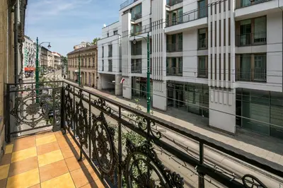a balcony in a city with buildings at The Royal Patch Aparthotel in Kraków
