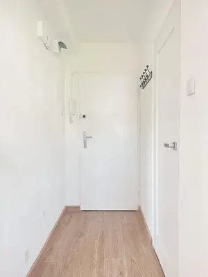 an empty room with white walls and a wooden floor at Apartment with private kitchen in the heart of Krakow, City Center in Kraków