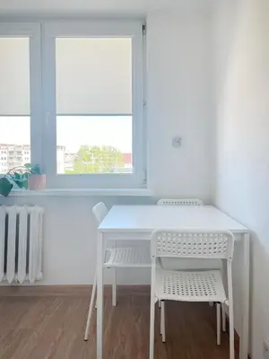 a white table and chairs in a room with a window at Apartment with private kitchen in the heart of Krakow, City Center in Kraków