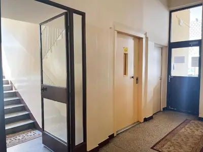 a hallway with a glass door and a staircase at Apartment with private kitchen in the heart of Krakow, City Center in Kraków