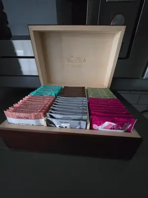 a wooden box filled with different colored books at Myśliwska Solar Garden Premium Apartment Wawelofts - free Garage in Kraków