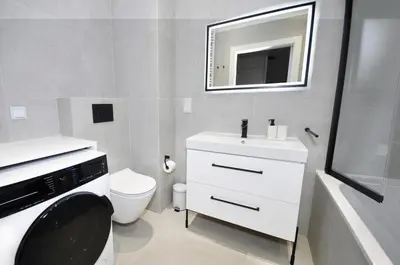 a bathroom with a toilet and a sink and a mirror at Myśliwska Solar Garden Premium Apartment Wawelofts - free Garage in Kraków